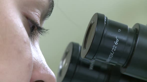 Closeup Of Eyes Looking Through Microscope (2 Of 3)