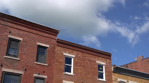Puffy Clouds Over A Brick Building (3 Of 4)