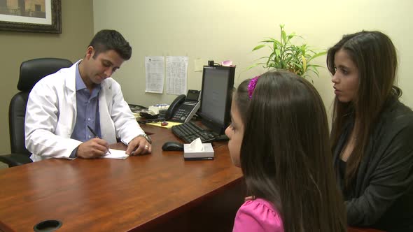 Male Doctor Consults With Mother And Daughter (5 Of 7)