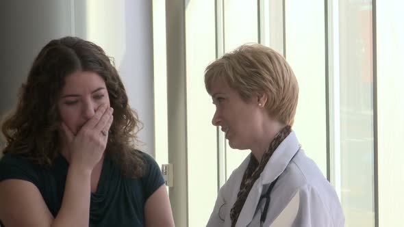 Female Doctor Comes In To Speak To Her Female Patient (2 Of 5)