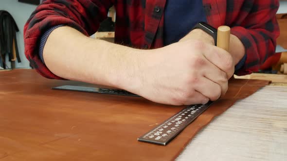 Young Craftsman Makes a Line of Markings on the Leather Cloth Using a Ruler. Handmade Leather alt