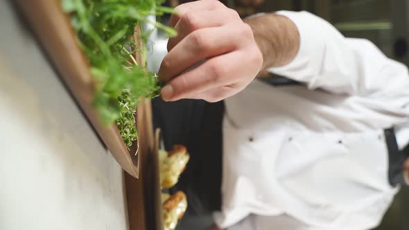 Closeup Male Chef Hands Taking Greens For Finishing Dish