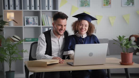 Modern Graduation Charming Graduate in Academic Attire Hugs Her Husband During Graduation Ceremony