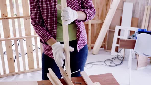 Stylish craftswoman working in carpentry. Woodwork and furniture making concept. alt