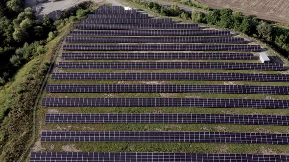 Solar Power Station in Green Field on Sunny day. Aerial view. alt