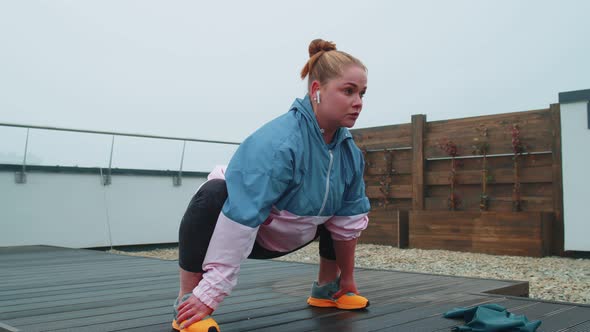 Fit Girl Making Workout Cardio Training Exercises Outdoors Squats Yoga Stretching Exercising on Roof alt