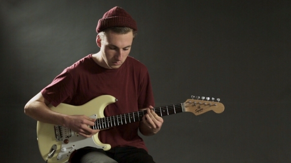 Pensive Guitarist Playing Guitar In a Dark Studio, Stock Footage ...