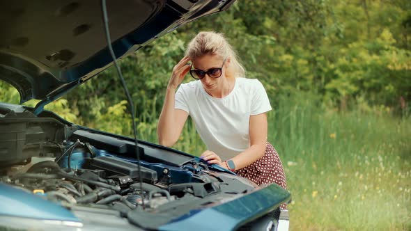 Auto Failure Accident Inspection Oil Level. Frustrated Girl Repairing Damage Car. Engine Oil Level. alt