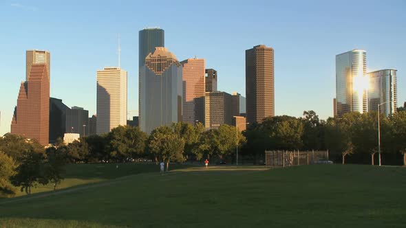 Joggers Run Beneath The Houston Skyline
