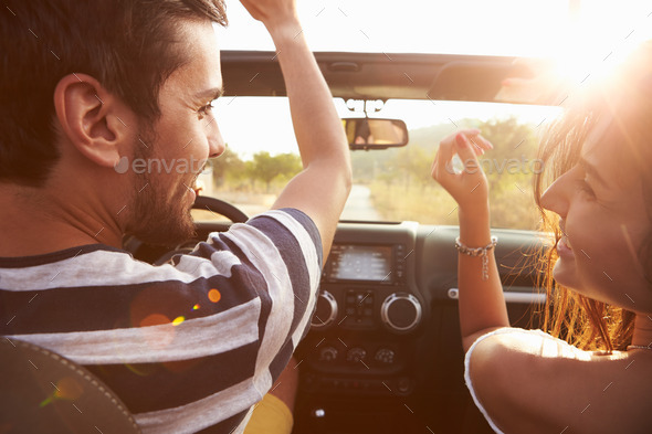 Young Couple Driving Along Country Road In Open Top Car - Stock Photo - Images