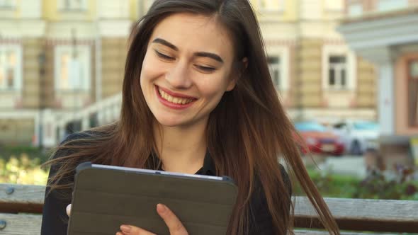 Girl Watches Something Funny on the Tablet alt