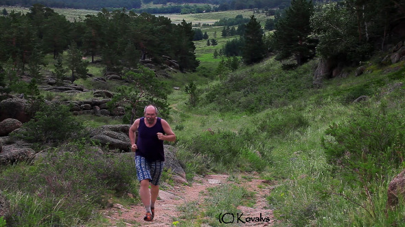 Man Jogging On The Mountain Valley