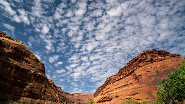 Timelapse of clouds moving over Hog Canyon in the Utah desert alt
