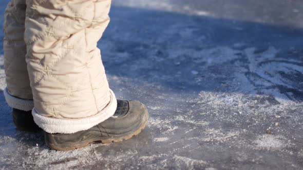 A Child Walks on Ice Without Skates.