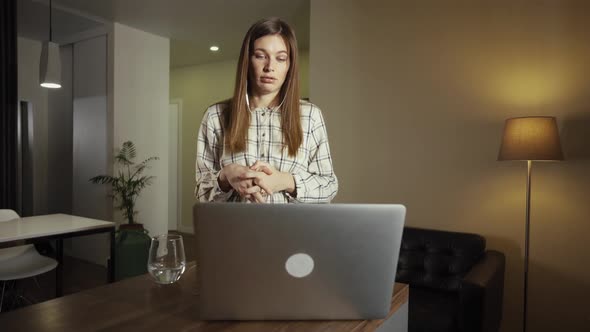 Female Working From Home. Having a Video Call with Colleagues alt