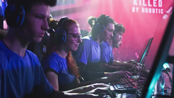 Focused Men and Women Playing Video Game During Competition alt