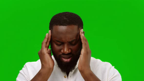 African american man with pain in his temples, suffering from stress or headache grimacing in pain