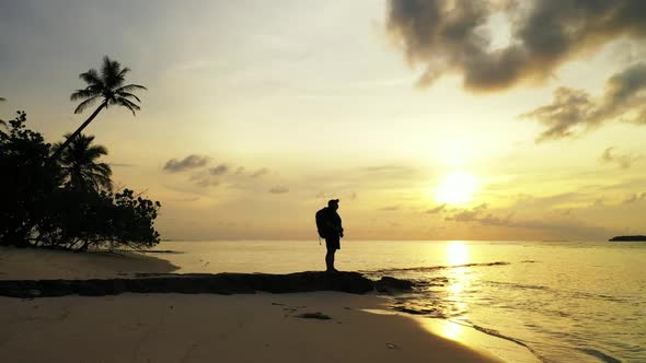 One woman enjoys life on marine shore beach break by clear ocean with white sandy background of the  alt