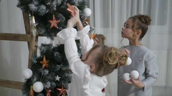 Happy American family celebrating Christmas. Children open a gift at home. alt