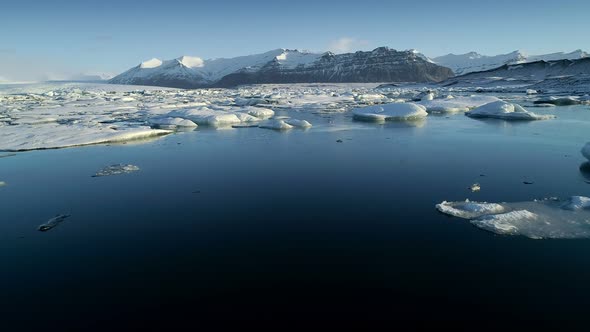 Flying Above Floating Icebergs. Ice From Glacier Crystal Shining. Ice Lagoon Global Warming