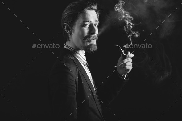 Young gentlemen smokes a pipe - Stock Photo - Images