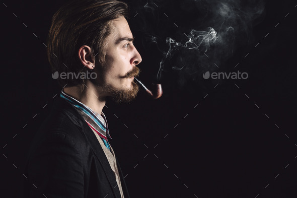 Young gentlemen smokes a pipe - Stock Photo - Images