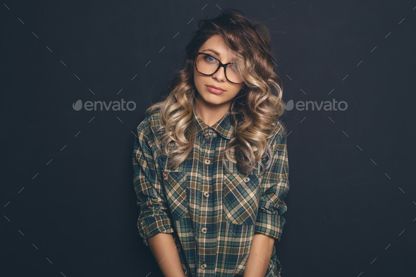 Portrait of a young beautiful blond-haired wearing trendy glasse