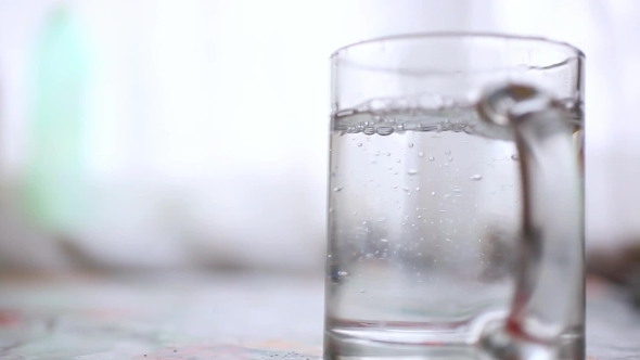 pouring-boiling-water-into-a-glass-and-brewing-tea-stock-footage