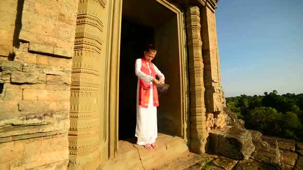 Female Buddhist Praying With Incense In Temple Doorway - Angkor Wat Temple Cambodia