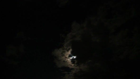 Full Moon Passing Between Clouds