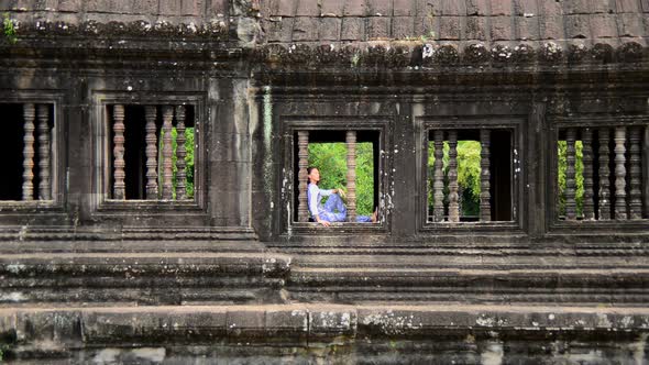 Female Buddhist Meditating In Window - Angkor Wat, Cambodia