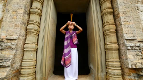 Female Buddhist Praying With Incense In Temple Doorway -   Angkor Wat Temple Cambodia 2