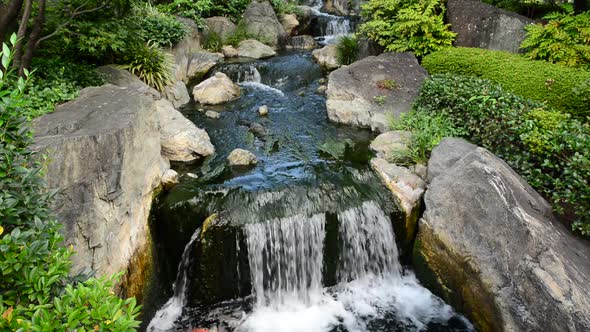 Waterfall Runs Into A Coy Pond At Sensoji Temple Tokyo Japan
