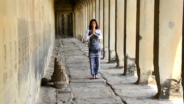 Female Buddhist With Hands In Prayer In Temple Hallway  - Angkor Wat Temple Cambodia