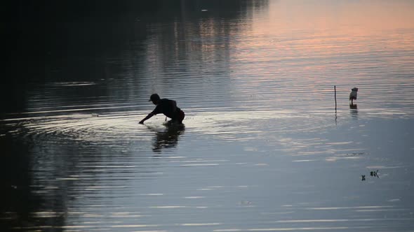 Silhouette Of Man Fishing In The River In The Morning - Angkor Wat, Cambodia