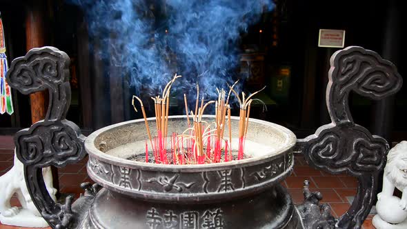 Incense Sticks Burning In Giant Pot In Front Of Buddhist Temple 1