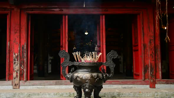 Incense Sticks Burning In Giant Pot In Front Of Buddhist Temple 7