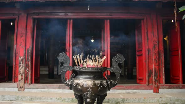 Incense Sticks Burning In Giant Pot In Front Of Buddhist Temple 8