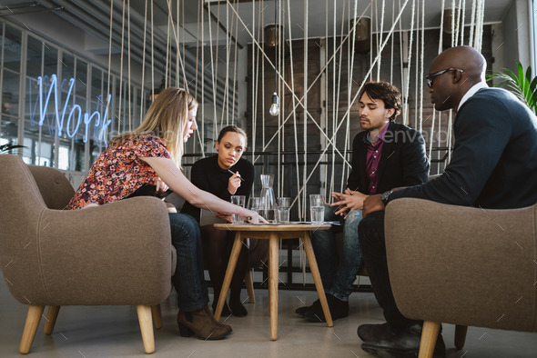 Diverse group of executives discussing business - Stock Photo - Images