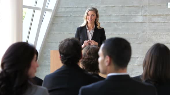 Businesswoman Giving Presentation At Conference 1 alt