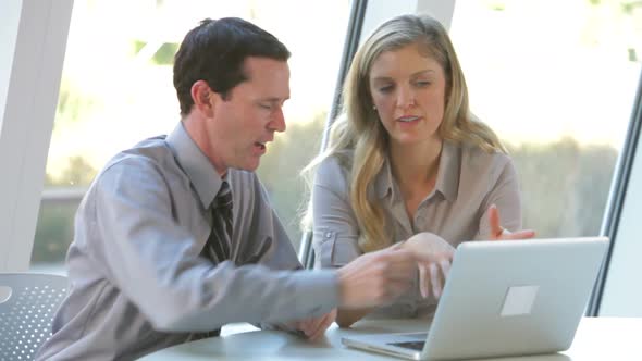 Two Business People With Laptop Having Meeting 2 alt