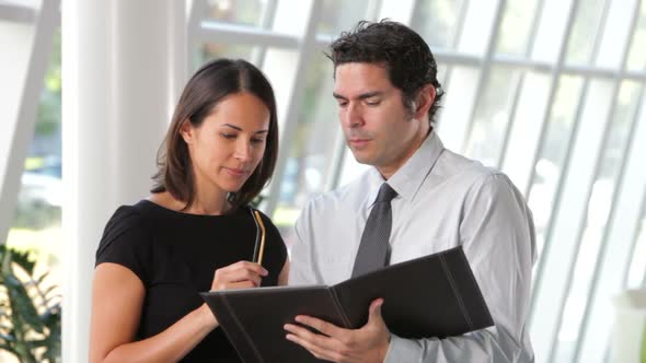 Two Businessmen Discussing Document In Office 1