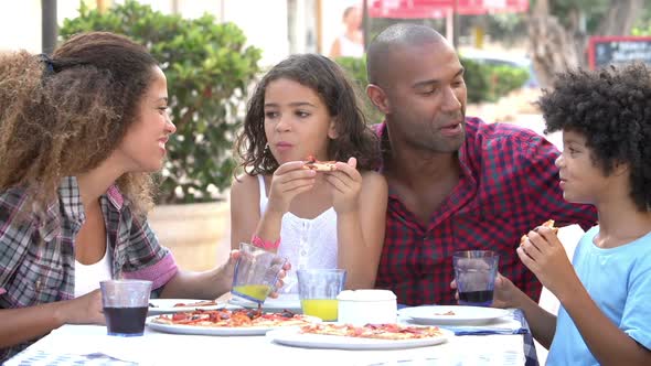 Family Eating Meal At Outdoor Restaurant Together 1 alt