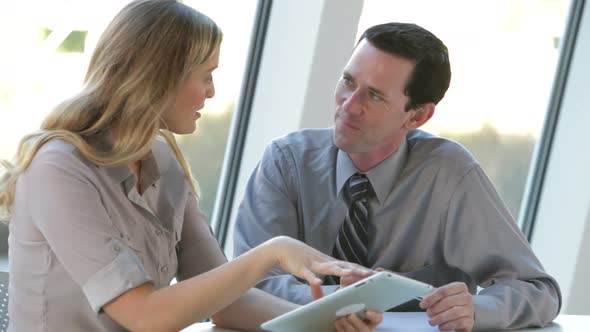 Two Businesspeople With Digital Tablet At Meeting 1