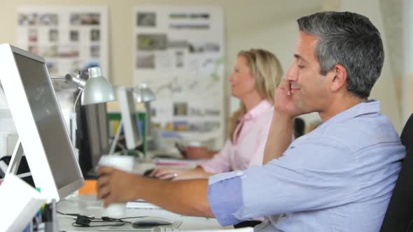 Man At Desk With Mobile Phone Drinking Coffee 1 alt
