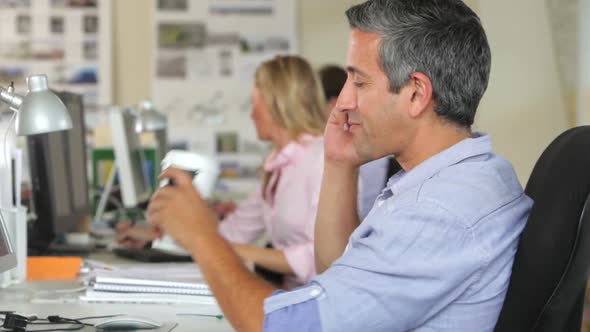 Man At Desk With Mobile Phone Drinking Coffee 2 alt