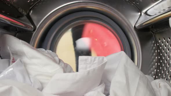 Woman Putting Laundry Into Washing Machine 2 alt