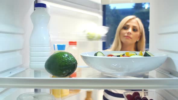 Woman Taking Bottle Of Milk From The Fridge alt