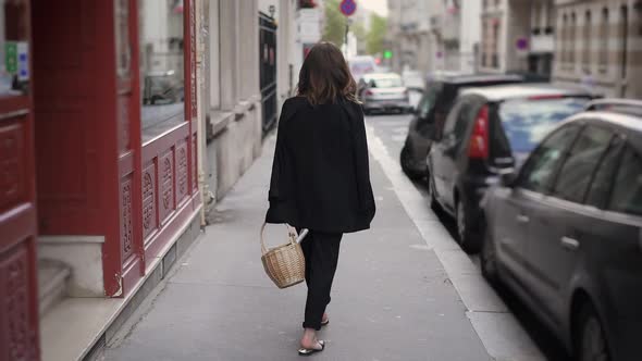 Slow Motion Back View of Woman on the Street Walking with a Wicker Basket