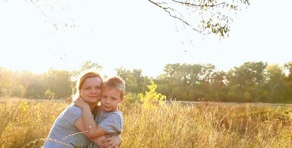 Portrait of Mother and Child in Meadow in Sunset